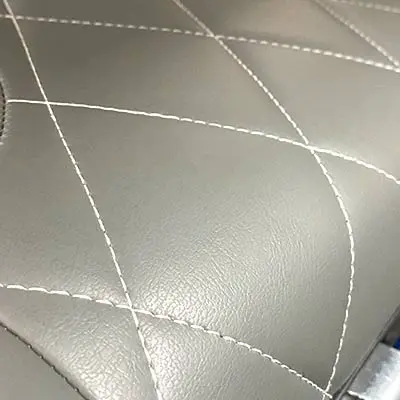 Closeup of gray leather seats with white stitching
